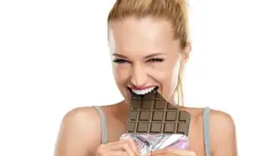 _117853865_girl-eating-a-chocolate-bar.jpg