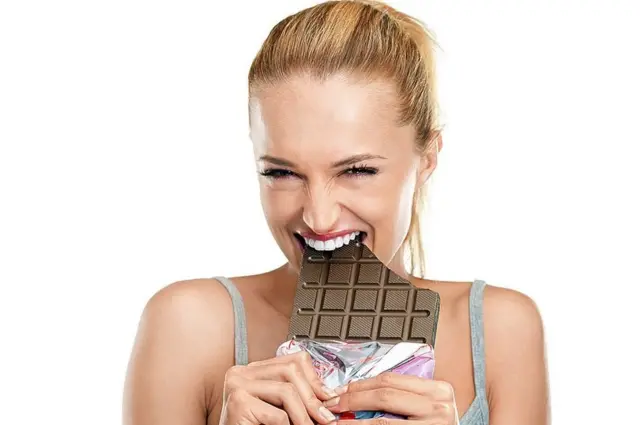 _117853865_girl-eating-a-chocolate-bar.jpg