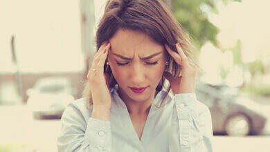 stressed sad young woman standing outdoors. City life style stress